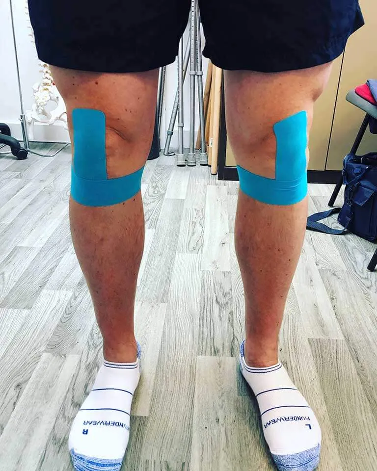 Kinesiology tape applied to both knees.